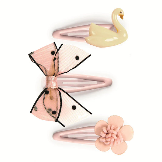 Set of three hair clips with butterfly, swan, and flower designs on a white background